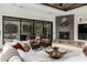 Bright living room with a unique ceiling, fireplace, patio access, and stylish furniture at 27708 N 110Th Pl, Scottsdale, AZ 85262