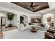 Open-concept living room with decorative ceiling, modern furnishings, and seamless access to the kitchen at 27708 N 110Th Pl, Scottsdale, AZ 85262