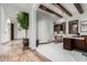 An office features wooden beams, white walls, and an elegant desk with a rocking chair at 27708 N 110Th Pl, Scottsdale, AZ 85262
