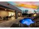 Resort-style outdoor space featuring swimming pool, dining area, and open access to interior at 27708 N 110Th Pl, Scottsdale, AZ 85262