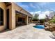 Inviting backyard pool and patio area with seamless indoor/outdoor living and a lovely rock waterfall feature at 27708 N 110Th Pl, Scottsdale, AZ 85262