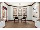 Bright sitting room with two chairs, dark wood trim, stone columns, and large arched windows that bring in ample light at 27708 N 110Th Pl, Scottsdale, AZ 85262