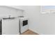 This laundry room includes a washer, a dryer, a shelf and natural light at 2828 W Eagle Talon Rd, Phoenix, AZ 85085