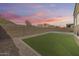 The backyard offers an artificial lawn, providing a low-maintenance and inviting outdoor space at 32366 N 133Rd Ln, Peoria, AZ 85383