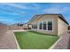 Home's artificial grass backyard with desert landscape and blue sky views at 32366 N 133Rd Ln, Peoria, AZ 85383