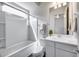 A well-lit bathroom features a shower-tub combo and a sleek vanity, perfect for relaxation at 32366 N 133Rd Ln, Peoria, AZ 85383