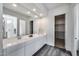 Bathroom with white double vanity, walk-in glass shower, and large mirror at 32366 N 133Rd Ln, Peoria, AZ 85383