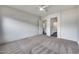 Carpeted bedroom with ceiling fan, white walls, and doorway to kitchen at 32366 N 133Rd Ln, Peoria, AZ 85383