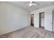 This bedroom features neutral carpeting, bright natural light and a walk-in closet at 32366 N 133Rd Ln, Peoria, AZ 85383