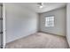 A bright bedroom with neutral carpeting and a window, creating a blank canvas for personalization at 32366 N 133Rd Ln, Peoria, AZ 85383