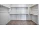 Walk-in closet with shelving and gray carpet at 32366 N 133Rd Ln, Peoria, AZ 85383