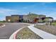 Community clubhouse with modern architecture, attractive landscaping, and ample parking at 32366 N 133Rd Ln, Peoria, AZ 85383