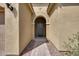 An arched entryway leads to the front door with stone pavers and desert landscaping at 32366 N 133Rd Ln, Peoria, AZ 85383
