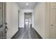The neutral interior showcases a long hallway with gray tile and white walls at 32366 N 133Rd Ln, Peoria, AZ 85383