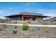 Exterior view of the community building featuring a covered patio and landscaped desert grounds at 32366 N 133Rd Ln, Peoria, AZ 85383