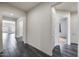 A bright hallway features neutral walls and a long hallway with gray tile flooring at 32366 N 133Rd Ln, Peoria, AZ 85383