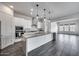 Open-concept kitchen with a large island, stainless steel appliances, and sleek white cabinetry at 32366 N 133Rd Ln, Peoria, AZ 85383