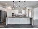 Modern kitchen featuring a large island, stainless steel appliances, and contemporary design at 32366 N 133Rd Ln, Peoria, AZ 85383