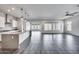 Open floorplan of the living room and kitchen with tile floors, recessed lighting, and modern design at 32366 N 133Rd Ln, Peoria, AZ 85383