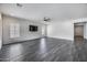 Spacious living room with tile flooring, recessed lights, ceiling fan, and large windows at 32366 N 133Rd Ln, Peoria, AZ 85383