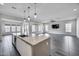Open-concept living room and kitchen showcasing the bright space, tile floors, and large island at 32366 N 133Rd Ln, Peoria, AZ 85383