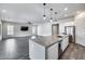 Open-concept living room and kitchen featuring tile flooring, ample natural light, and recessed lighting at 32366 N 133Rd Ln, Peoria, AZ 85383