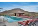 Community pool surrounded by lounge chairs offers a relaxing oasis with scenic mountain backdrop at 32366 N 133Rd Ln, Peoria, AZ 85383