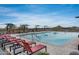 Community pool area showcases lounge chairs, umbrellas, and a view of the surrounding mountains at 32366 N 133Rd Ln, Peoria, AZ 85383