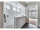 Walk-in glass shower with white tile, dual shower heads, and small windows at 32366 N 133Rd Ln, Peoria, AZ 85383