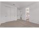 Bedroom with carpet, closet, and open door to a full bathroom at 40499 W Michaels Dr, Maricopa, AZ 85138