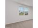 Carpeted bedroom with bright windows providing lots of natural light at 40499 W Michaels Dr, Maricopa, AZ 85138