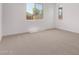 Spacious bedroom with soft carpet and natural light from the large window at 40499 W Michaels Dr, Maricopa, AZ 85138
