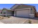 Beautiful home featuring a two-car garage and a paved driveway at 40499 W Michaels Dr, Maricopa, AZ 85138