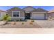 Beautiful home with a neutral color scheme, a two-car garage, and desert landscaping at 40499 W Michaels Dr, Maricopa, AZ 85138