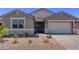 Charming single-Gathering home with stone accents, desert landscaping, and a two-car garage at 40499 W Michaels Dr, Maricopa, AZ 85138