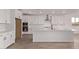 Bright kitchen features stainless appliances, sleek white cabinetry, and a spacious center island at 40499 W Michaels Dr, Maricopa, AZ 85138