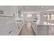 Open kitchen featuring white cabinetry, subway tile backsplash, quartz countertops, and stainless appliances at 40499 W Michaels Dr, Maricopa, AZ 85138