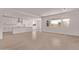 Spacious living area with open-concept layout to kitchen, large windows for natural light, and tile flooring at 40499 W Michaels Dr, Maricopa, AZ 85138