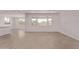 Bright living room with modern tile floors, and view to backyard at 40499 W Michaels Dr, Maricopa, AZ 85138