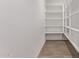 Walk-in pantry with white shelving providing ample storage space for dry goods and supplies at 40499 W Michaels Dr, Maricopa, AZ 85138