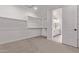 Walk-in closet with shelving offering ample storage, leading to the bathroom at 40499 W Michaels Dr, Maricopa, AZ 85138