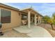 Inviting covered back patio, perfect for outdoor seating and relaxing, overlooks well-maintained landscaping at 42266 W Sparks Dr, Maricopa, AZ 85138