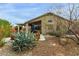 Backyard featuring desert landscaping, covered patio area, and a neutral color scheme at 42266 W Sparks Dr, Maricopa, AZ 85138