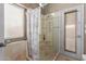 Bathroom featuring tile shower with glass door and backyard access at 42266 W Sparks Dr, Maricopa, AZ 85138