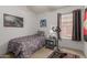 Well-lit bedroom featuring a single bed, decorative artwork, and a compact exercise machine at 42266 W Sparks Dr, Maricopa, AZ 85138