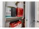 Neatly organized closet shelf with a variety of storage boxes, shredders and other essential supplies at 42266 W Sparks Dr, Maricopa, AZ 85138
