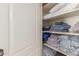 Organized linen closet with neatly stacked towels, pillows, and bedding, maximizing storage space at 42266 W Sparks Dr, Maricopa, AZ 85138
