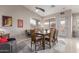 This dining area offers a vaulted ceiling, lots of natural light, and a dining table set for eight at 42266 W Sparks Dr, Maricopa, AZ 85138