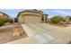Single-story home with a two-car garage and desert landscaping at 42266 W Sparks Dr, Maricopa, AZ 85138