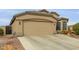 Single-story home featuring a two-car garage at 42266 W Sparks Dr, Maricopa, AZ 85138